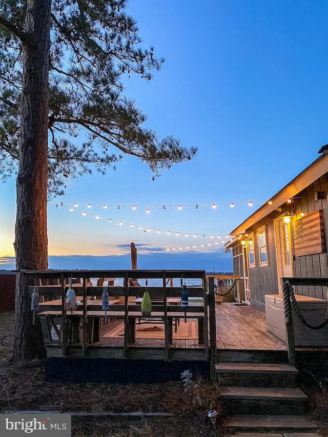 exterior space featuring a deck with water view