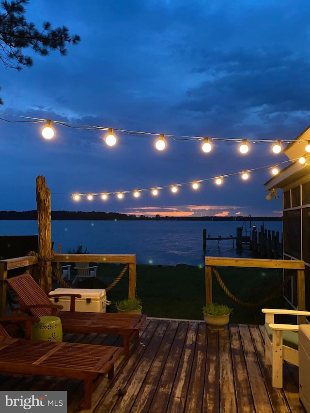 exterior space featuring a boat dock and a water view