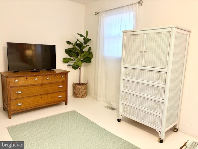 living area featuring visible vents and a healthy amount of sunlight