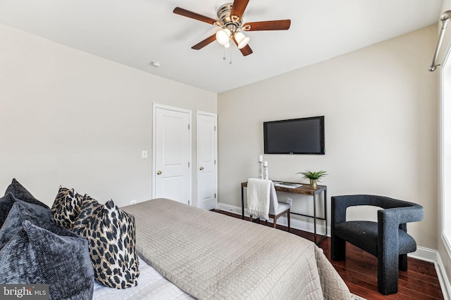 bedroom with dark wood-type flooring and ceiling fan