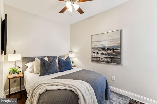 bedroom with ceiling fan and dark hardwood / wood-style floors