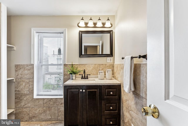 bathroom with vanity, tile walls, and backsplash