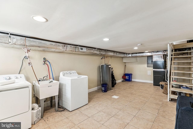 washroom featuring washer and dryer, sink, electric water heater, and heating unit