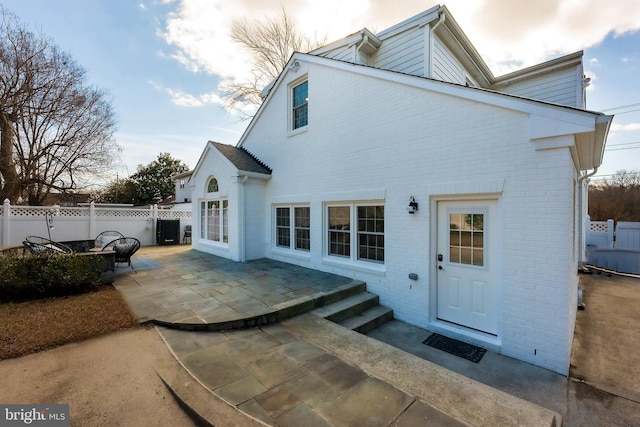 rear view of property featuring a patio