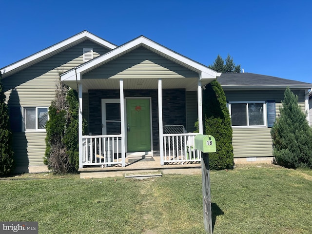 bungalow featuring a front yard and covered porch