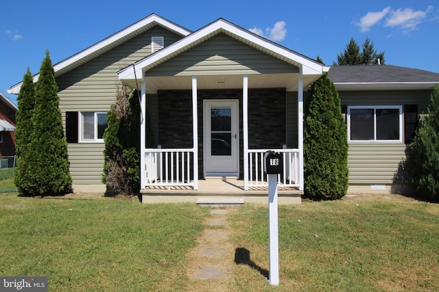 view of front facade with crawl space, a porch, and a front lawn