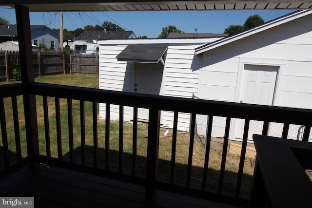 wooden deck featuring a lawn and a fenced backyard