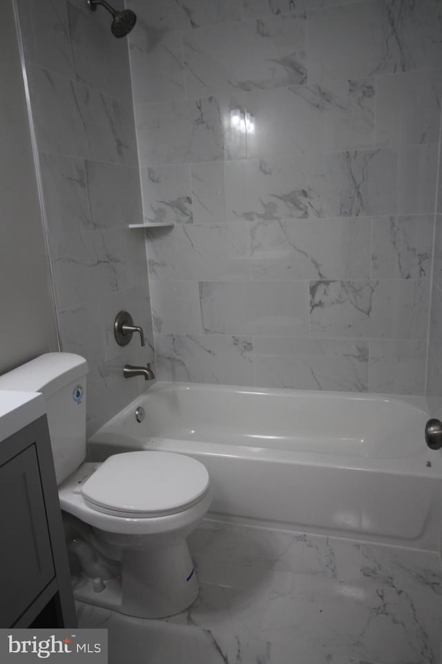 bathroom with vanity, toilet, washtub / shower combination, and marble finish floor