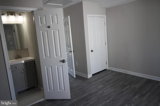 bathroom with vanity, baseboards, and wood finished floors