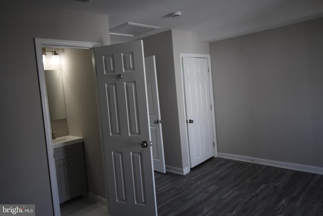 bathroom featuring vanity, wood finished floors, and baseboards