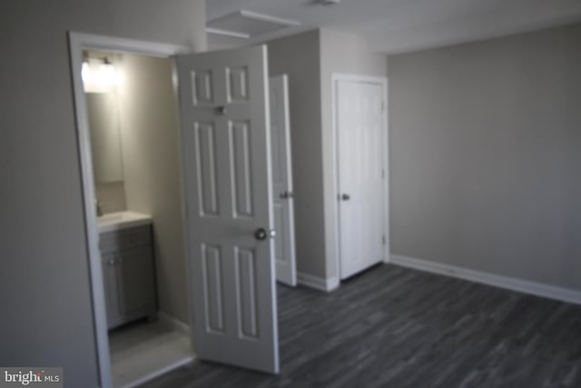 interior space featuring baseboards and dark wood-style flooring