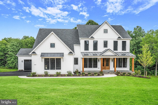 modern farmhouse style home featuring covered porch and a front yard