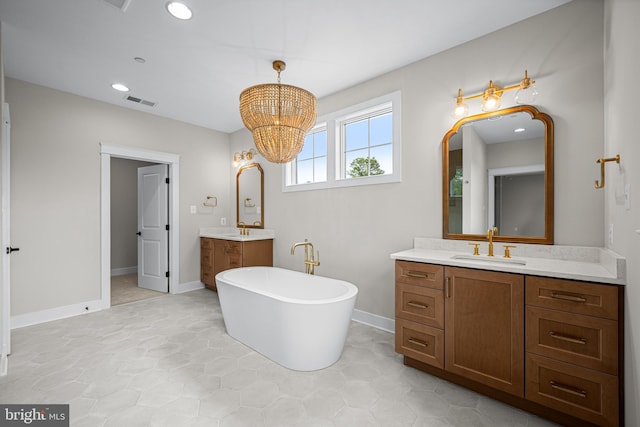 bathroom featuring vanity, a bathing tub, and a notable chandelier