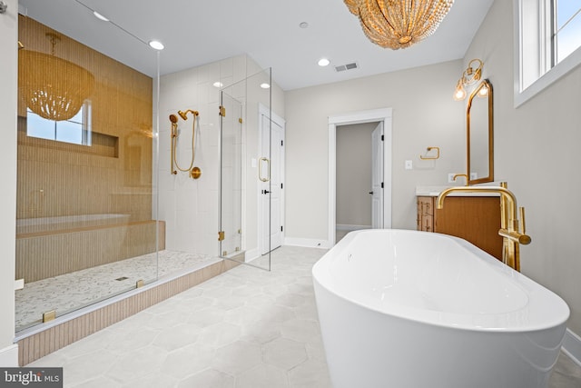 bathroom featuring vanity, a healthy amount of sunlight, and independent shower and bath