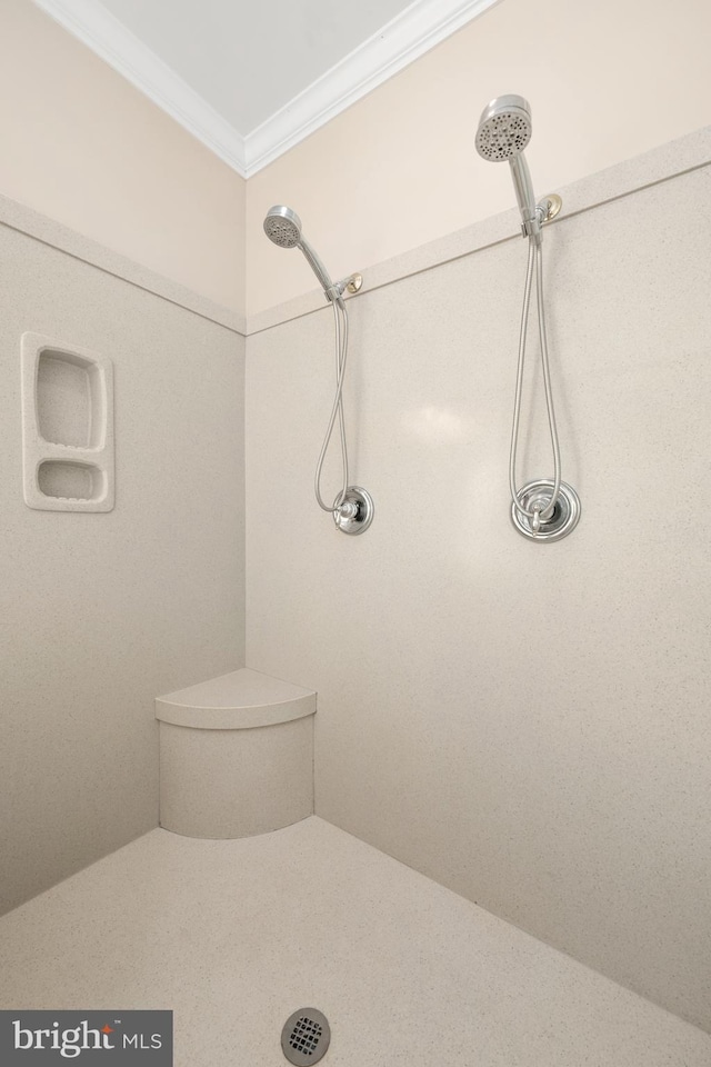 bathroom featuring crown molding, toilet, and a shower