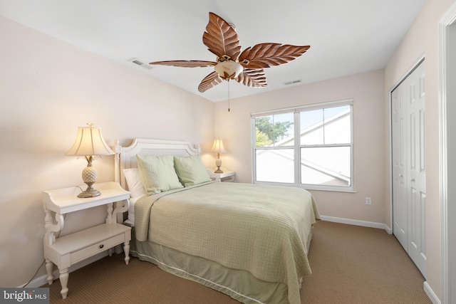 bedroom with a closet, ceiling fan, and carpet flooring