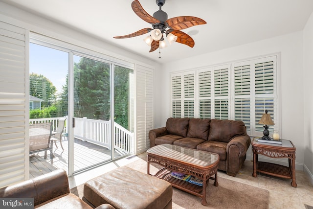 living room with light tile patterned floors and ceiling fan