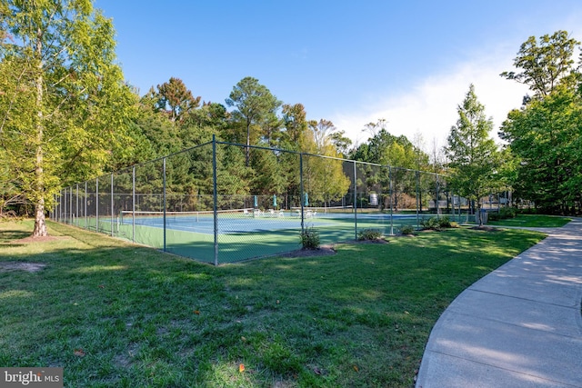 view of sport court featuring a lawn