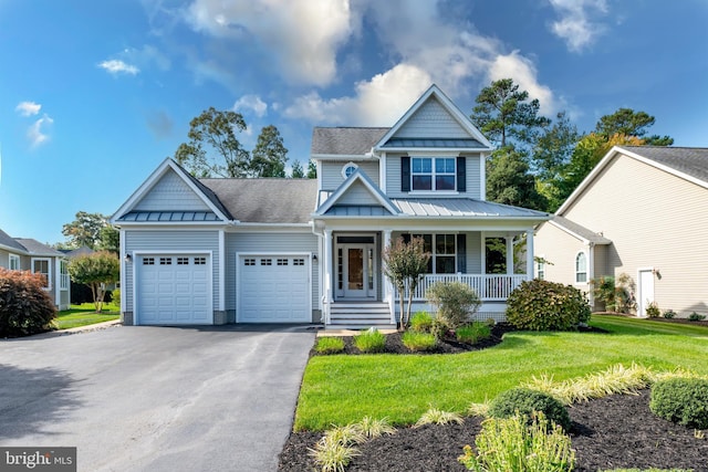 craftsman inspired home featuring a garage, a front lawn, and a porch