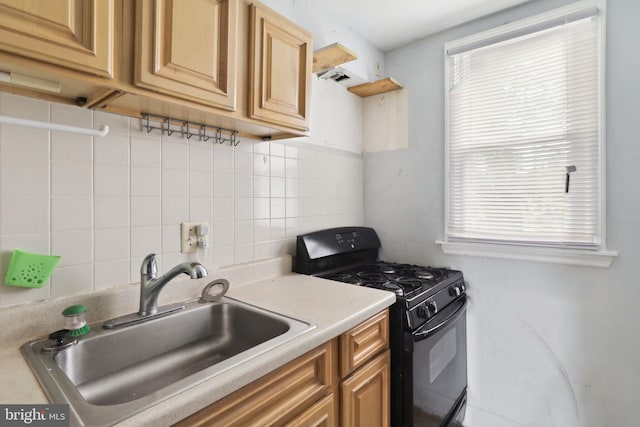 kitchen featuring plenty of natural light, sink, black range with gas cooktop, and decorative backsplash