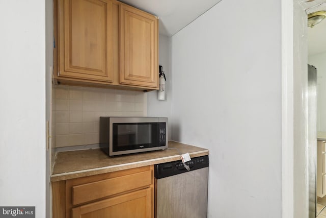 kitchen featuring appliances with stainless steel finishes and decorative backsplash