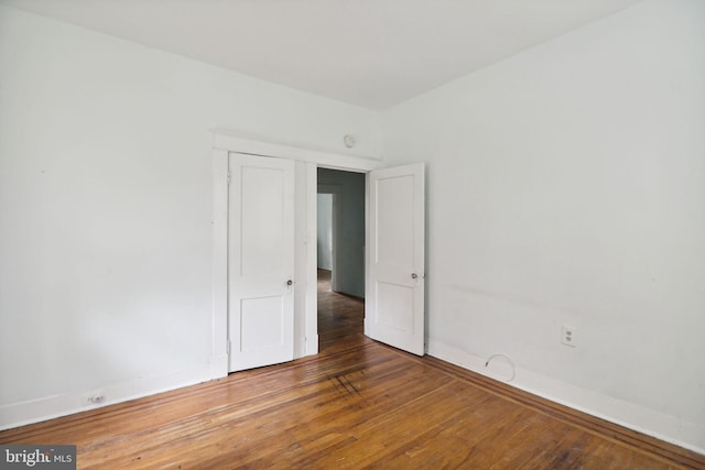 unfurnished room with hardwood / wood-style flooring