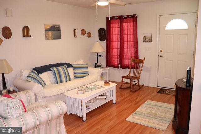 living room featuring ceiling fan and light hardwood / wood-style flooring