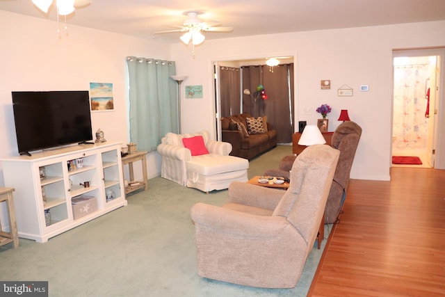 living room featuring ceiling fan and wood-type flooring