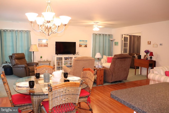 dining room featuring hardwood / wood-style floors and ceiling fan with notable chandelier