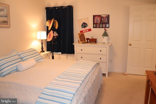 bedroom featuring light carpet