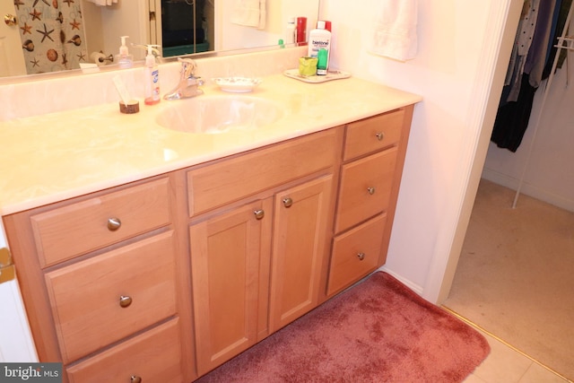 bathroom with carpet floors and vanity