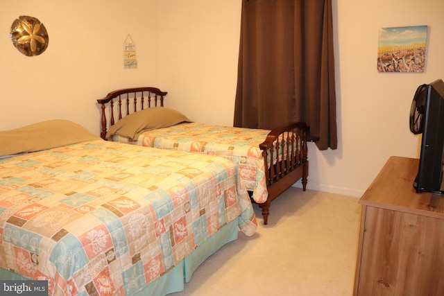 bedroom featuring light carpet