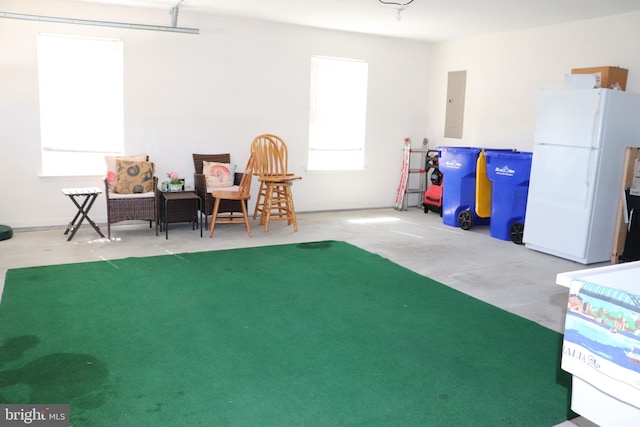 interior space with electric panel and freestanding refrigerator