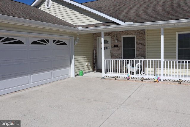 entrance to property with a garage and covered porch