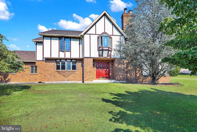 179 Owl Creek Rd, Tamaqua, PA 18252 - rear view of house with a chimney, a lawn, brick siding, and stucco siding