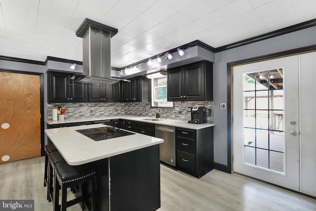 kitchen featuring ornamental molding, a center island, a healthy amount of sunlight, and sink