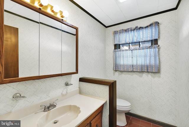 bathroom with crown molding, vanity, toilet, and tile patterned floors