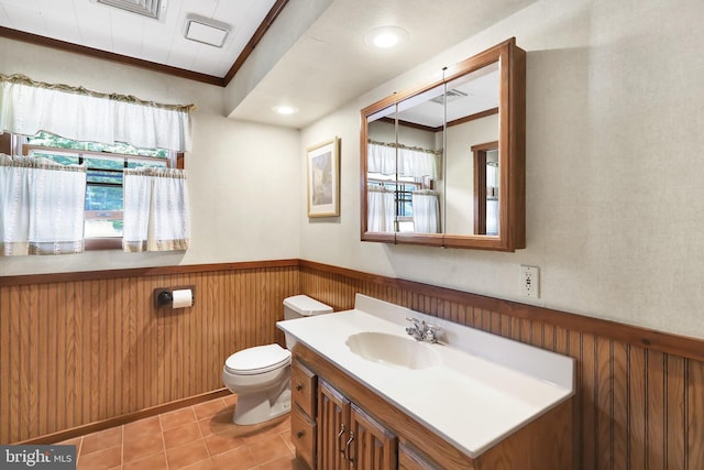 bathroom featuring ornamental molding, vanity, toilet, and tile patterned flooring