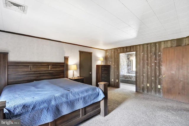 carpeted bedroom with ornamental molding