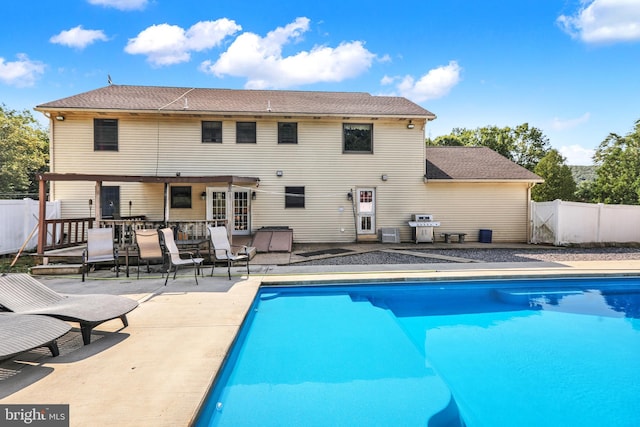 view of swimming pool with a patio area and a grill