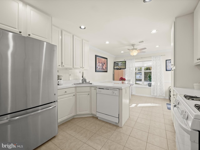 kitchen with white appliances, sink, kitchen peninsula, white cabinetry, and light tile patterned floors