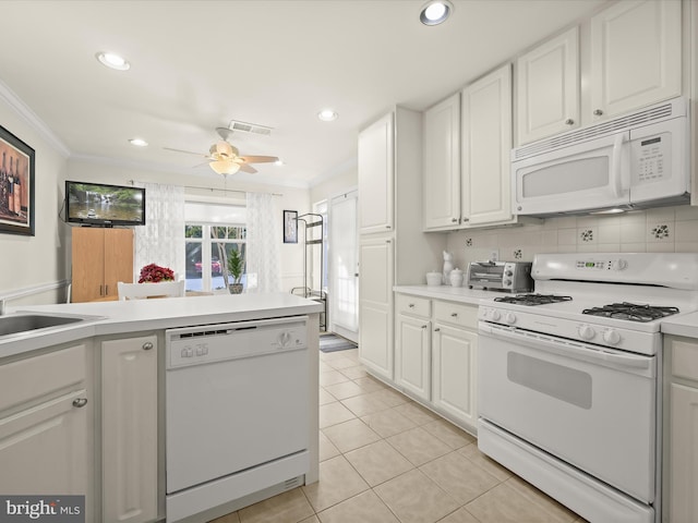 kitchen with crown molding, light tile patterned floors, white appliances, and white cabinetry