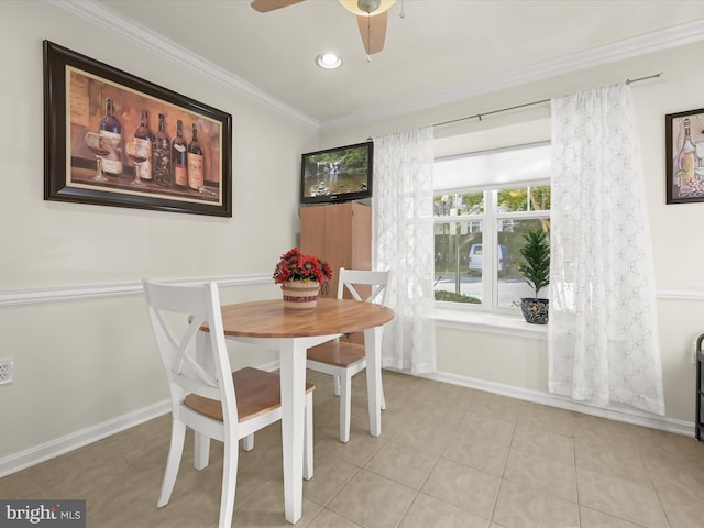 tiled dining area with ceiling fan and ornamental molding