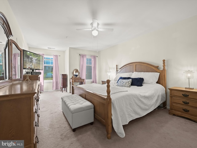 bedroom featuring light carpet and ceiling fan