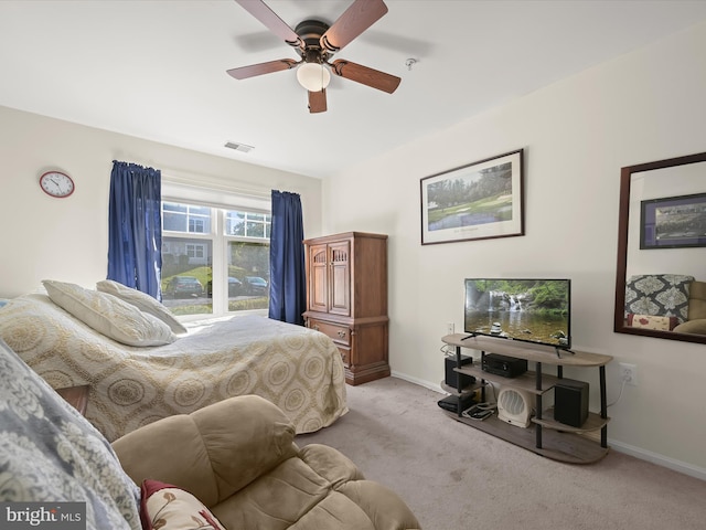 bedroom with ceiling fan and light colored carpet