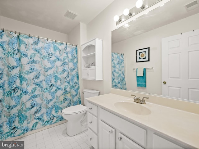 bathroom featuring vanity, tile patterned flooring, and toilet