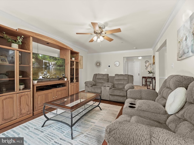 living room with ornamental molding, ceiling fan, and light hardwood / wood-style flooring