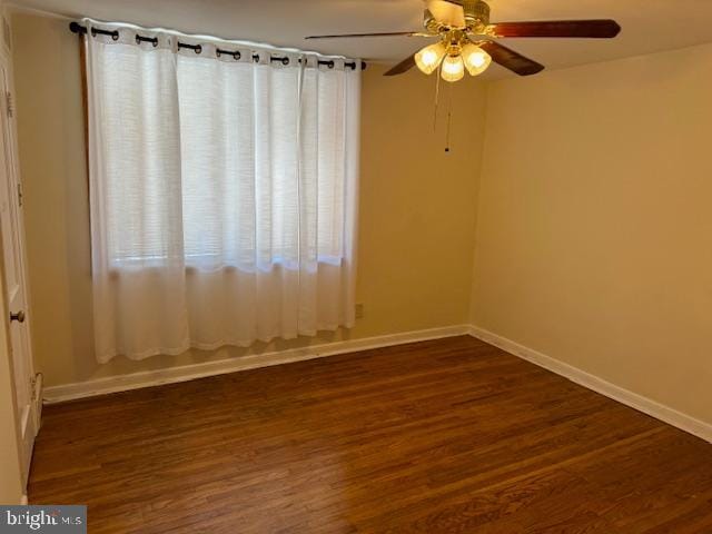 unfurnished room featuring ceiling fan and dark hardwood / wood-style flooring