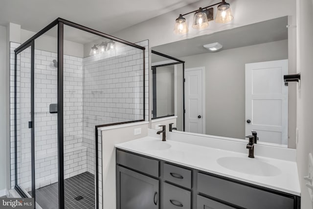 full bath featuring double vanity, a stall shower, and a sink