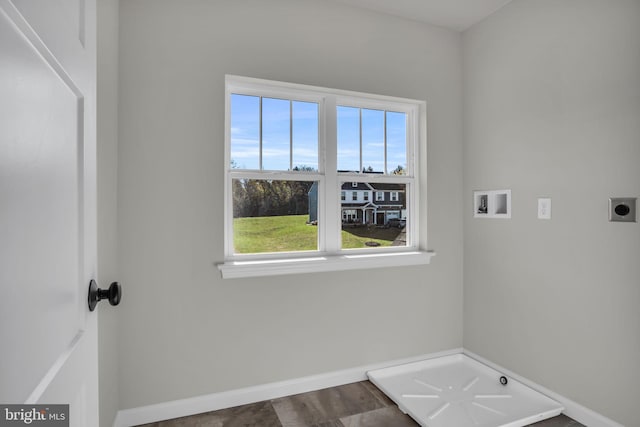 laundry room with baseboards, hookup for an electric dryer, hookup for a washing machine, and laundry area